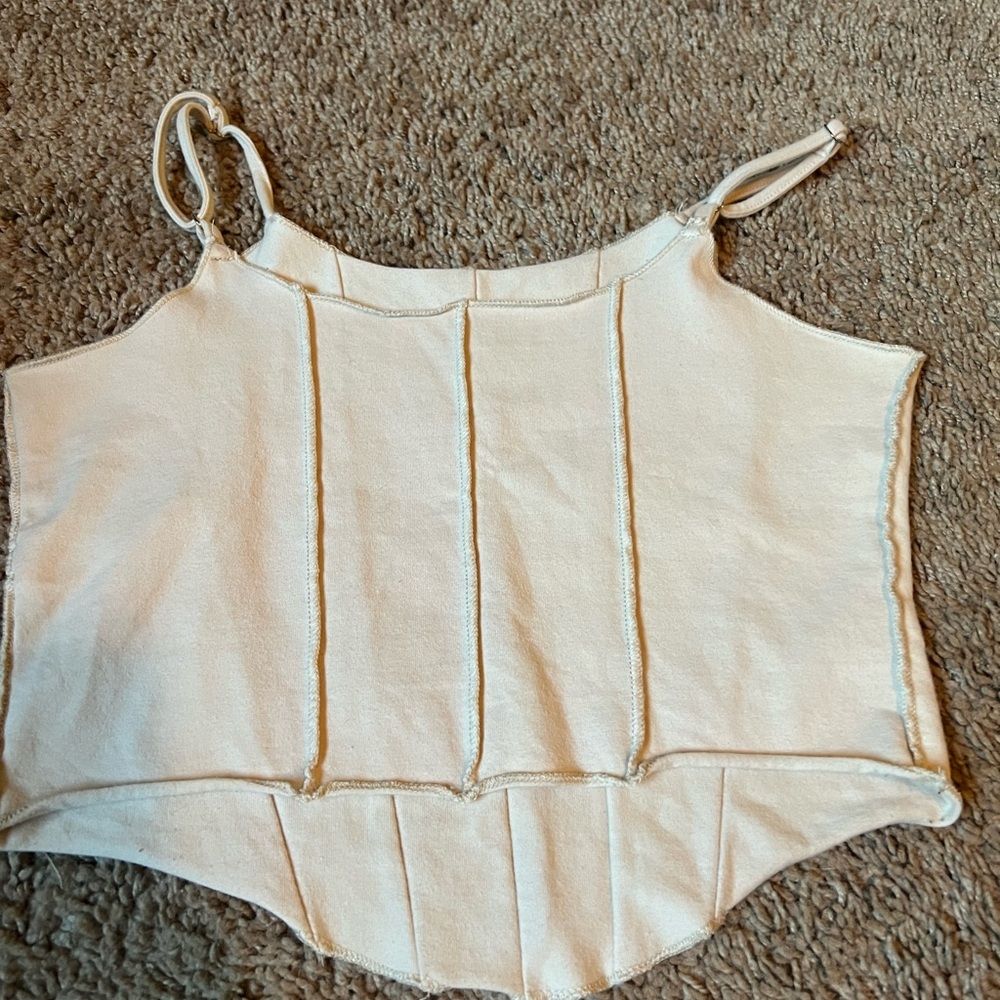 Cream top with piping detail on front
